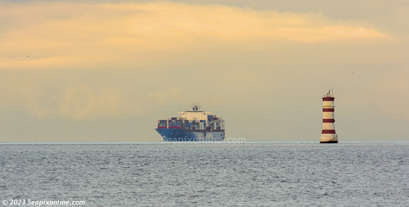 XIN XIA MEN (2004/66433gt/69259dwt/IMO 9270476/TEU 5668) in fast fading light, about to board her pilot as she approaches Rangitoto Lighthouse which guards the approaches to Auckland. This was her first call here with another visit scheduled for 25 February.
Built by Hudong-Zhonghua Shipbuilding in Shanghai, she is owned by China COSCO Shipping Corp, managed by COSCO Shipping Development and operated by Cosco Shipping Lines, all of Shanghai. 7 January 2023. Photo by Â© 2023 SeapixOnline.com